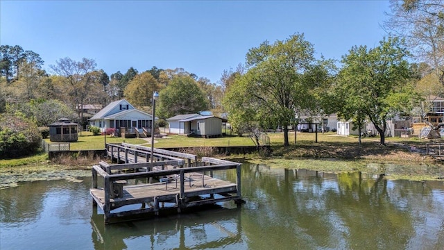 dock area featuring a lawn and a water view