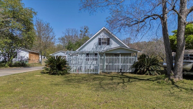 view of front of house featuring a fenced front yard, driveway, and a front yard