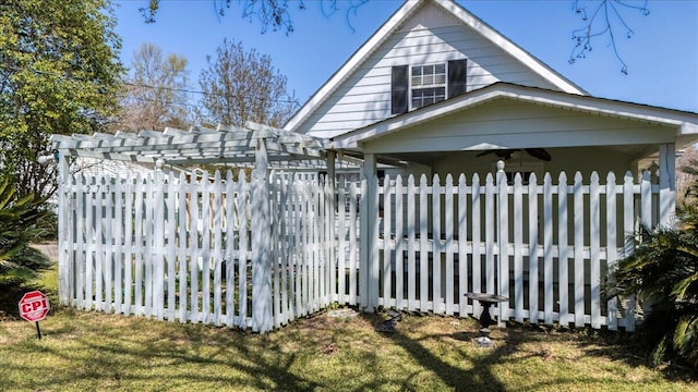view of side of home featuring a pergola and fence