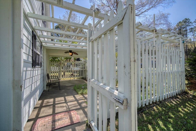 unfurnished sunroom featuring a ceiling fan