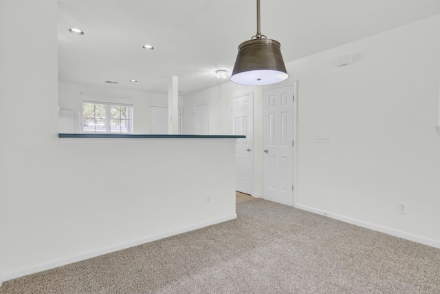 empty room with carpet flooring, baseboards, and recessed lighting