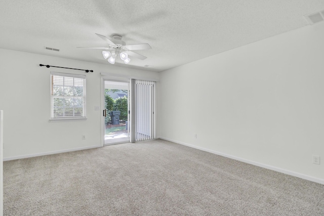 unfurnished room featuring carpet flooring, a ceiling fan, a textured ceiling, and baseboards