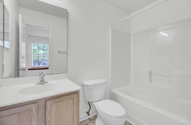 bathroom with toilet, vanity, baseboards, and shower / bath combination