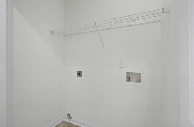 washroom with hookup for an electric dryer, hookup for a washing machine, and baseboards