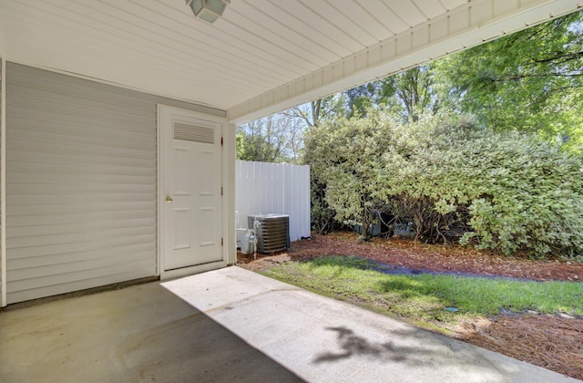 view of patio with central AC unit and fence
