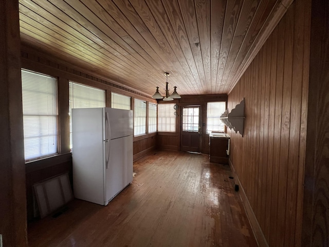 interior space featuring wood ceiling and a chandelier