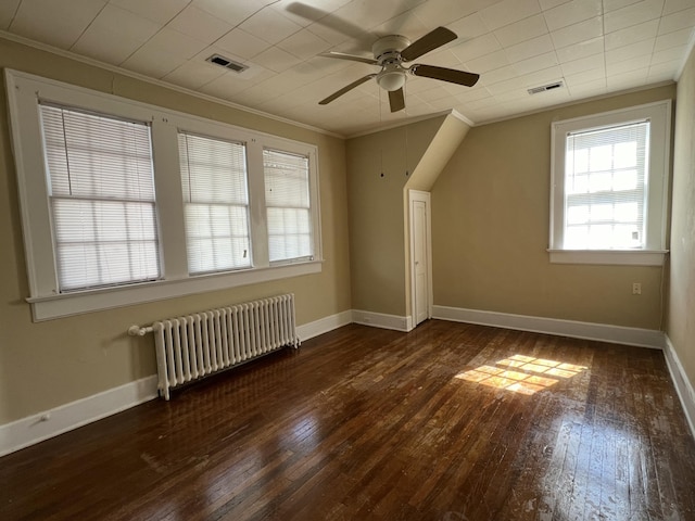 bonus room featuring visible vents, wood-type flooring, and radiator heating unit