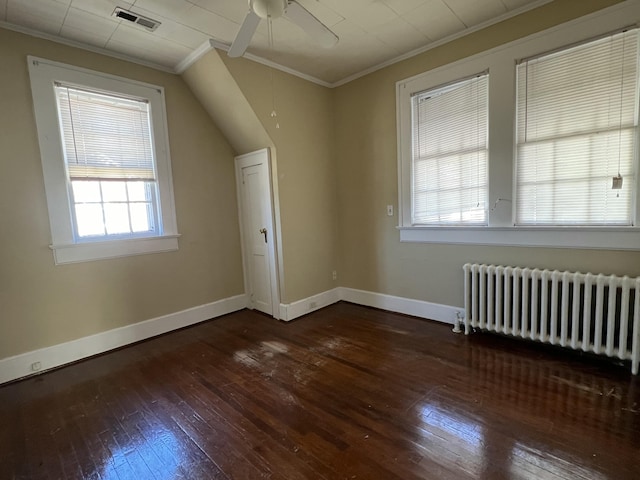 bonus room with visible vents, baseboards, radiator heating unit, hardwood / wood-style flooring, and a ceiling fan