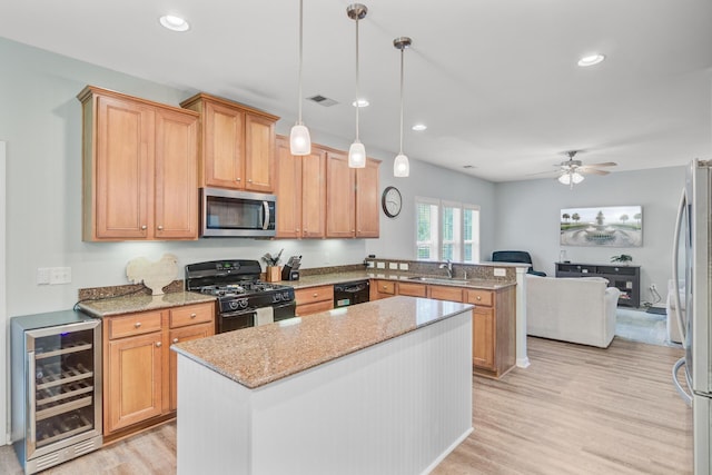 5433 Falling Tide, North Charleston, SC 29420 - kitchen with black appliances, beverage cooler, a sink, a peninsula, and light stone counters
