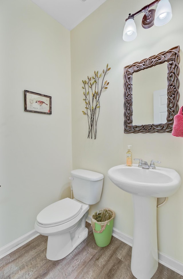 5433 Falling Tide, North Charleston, SC 29420 - half bath with baseboards, toilet, wood finished floors, and a sink