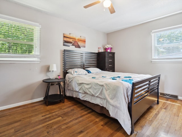 bedroom featuring wood-type flooring, multiple windows, and ceiling fan