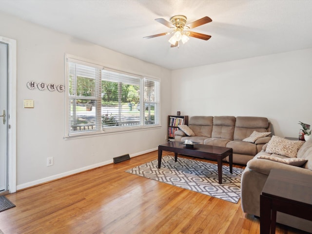 living room featuring ceiling fan and light hardwood / wood-style flooring