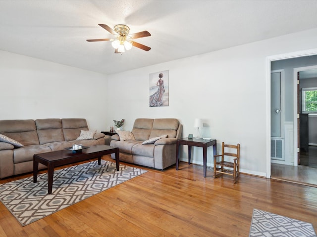 living room with ceiling fan and light hardwood / wood-style floors