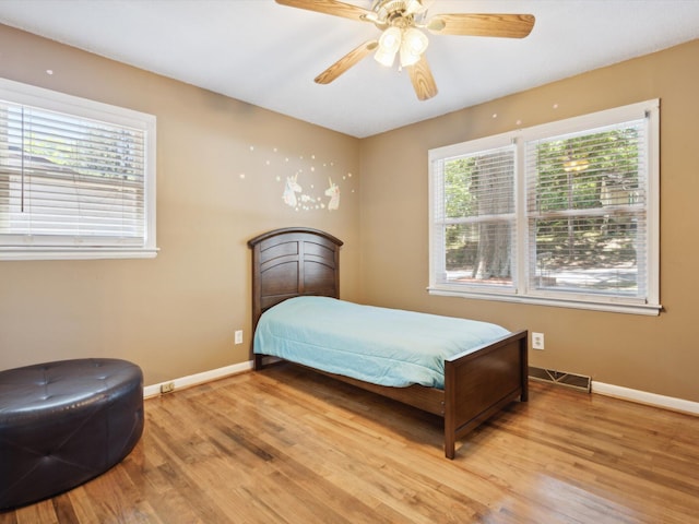 bedroom featuring light hardwood / wood-style floors and ceiling fan