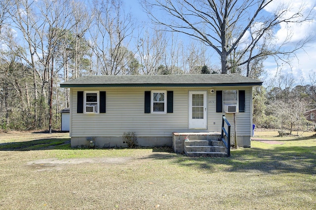 view of front facade featuring a front lawn, cooling unit, and roof with shingles