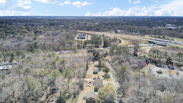 birds eye view of property featuring a view of trees