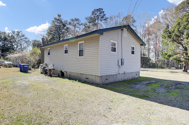 view of side of home featuring crawl space