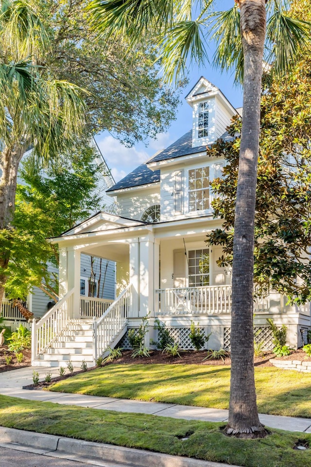 bungalow featuring a front yard and a porch