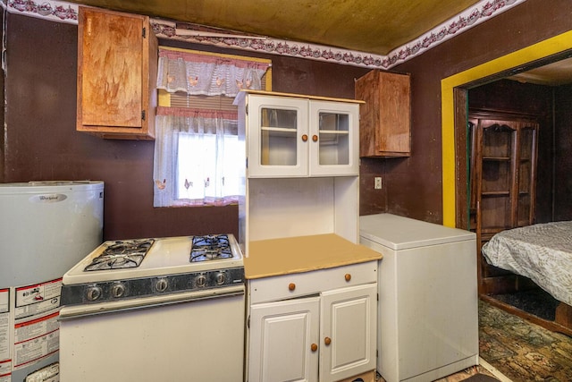 200 Fishburne St, Charleston, SC 29403 - kitchen with white range with gas cooktop, gas water heater, white cabinets, and light countertops