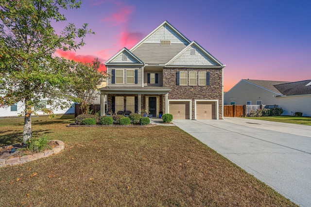 view of front of house featuring a yard and a garage