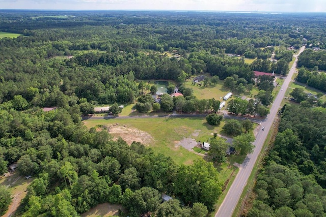 drone / aerial view featuring a wooded view