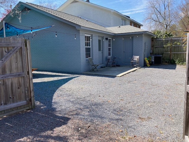 view of side of property with a patio area and central air condition unit