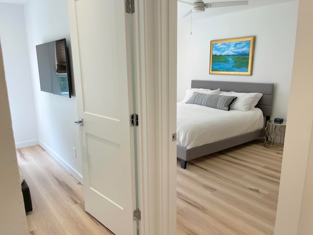 bedroom with ceiling fan and light hardwood / wood-style flooring