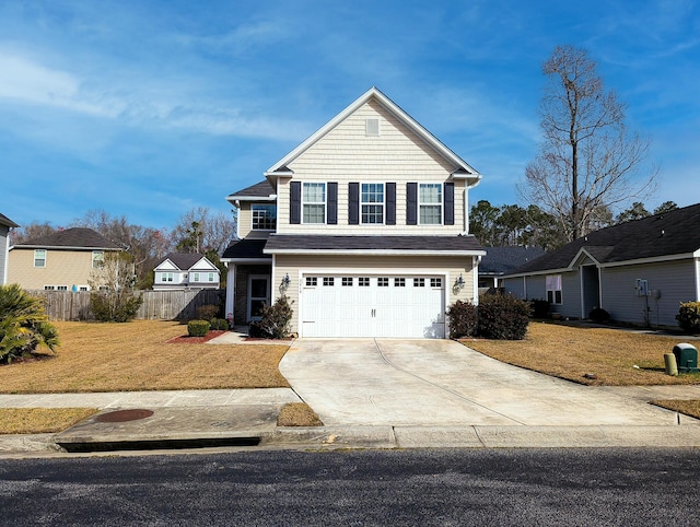 traditional-style home with driveway, a front lawn, a garage, and fence