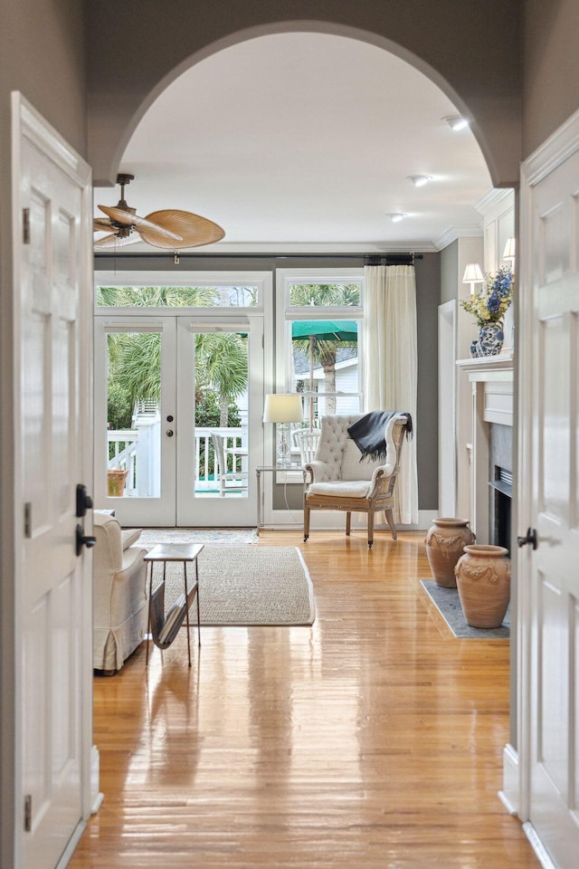 interior space with french doors, crown molding, and light hardwood / wood-style flooring