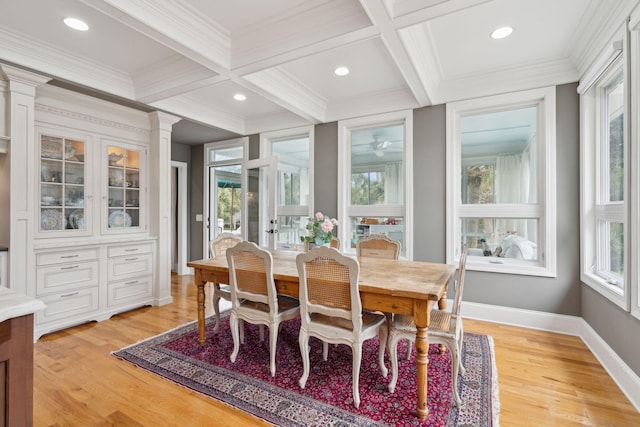 dining room with ornamental molding, coffered ceiling, beam ceiling, and light hardwood / wood-style floors