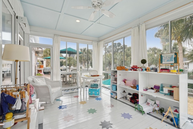 sunroom / solarium with ceiling fan and coffered ceiling