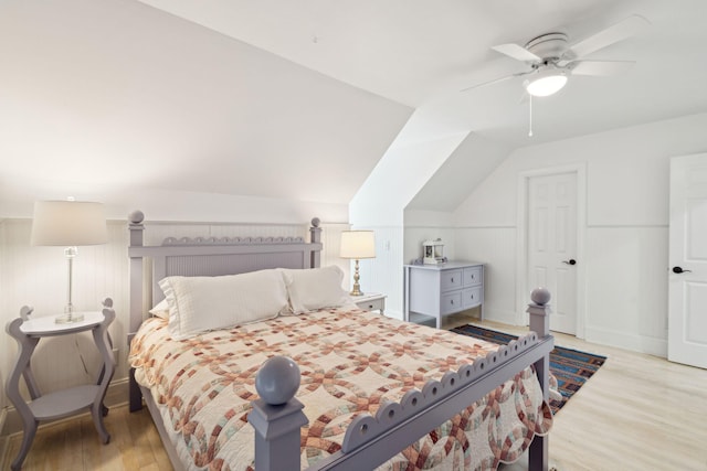 bedroom with ceiling fan, lofted ceiling, and light hardwood / wood-style floors