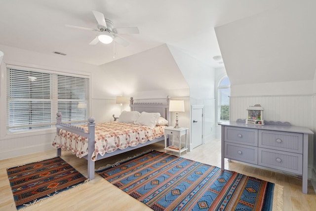 bedroom featuring ceiling fan, lofted ceiling, and light hardwood / wood-style flooring