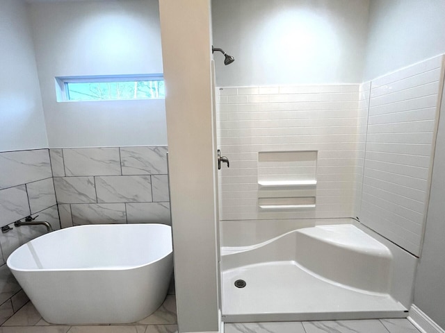 bathroom featuring independent shower and bath and tile walls