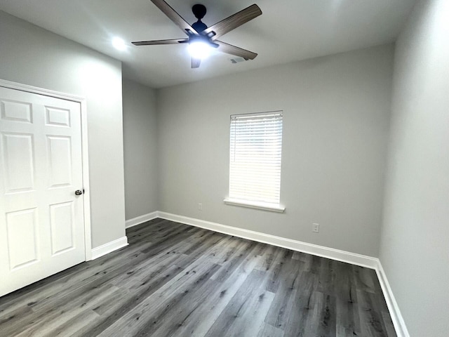 spare room featuring dark hardwood / wood-style floors and ceiling fan