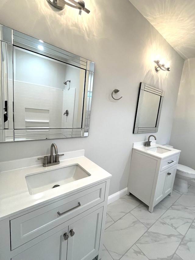 bathroom featuring vanity, a shower, and toilet