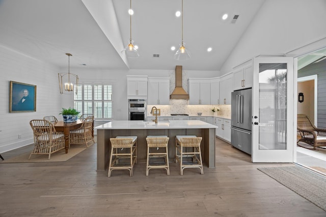1557 Kepley Dr, Mount Pleasant, SC 29464 - kitchen with stainless steel appliances, custom exhaust hood, a sink, white cabinetry, and a center island with sink