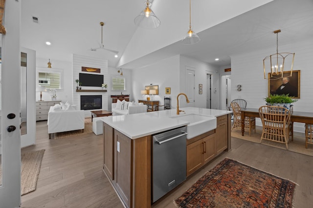 1557 Kepley Dr, Mount Pleasant, SC 29464 - kitchen featuring a sink, stainless steel dishwasher, wood finished floors, brown cabinetry, and recessed lighting