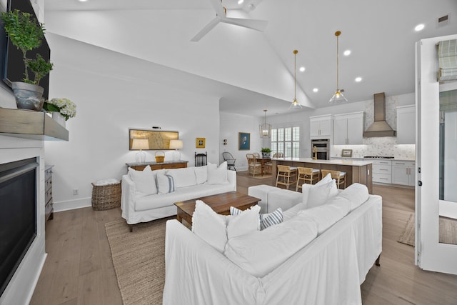 1557 Kepley Dr, Mount Pleasant, SC 29464 - living room with a fireplace, high vaulted ceiling, recessed lighting, ceiling fan, and light wood finished floors