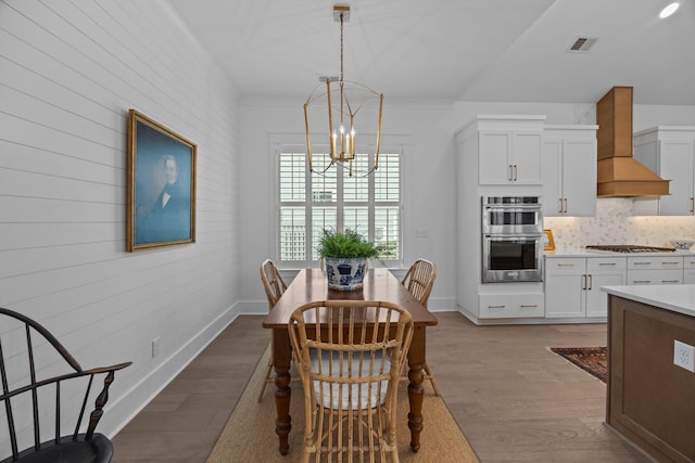1557 Kepley Dr, Mount Pleasant, SC 29464 - dining space with a chandelier, wood finished floors, wood walls, and baseboards