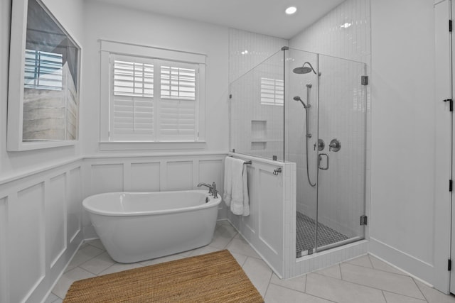1557 Kepley Dr, Mount Pleasant, SC 29464 - bathroom featuring a freestanding tub, a decorative wall, a shower stall, tile patterned floors, and a wainscoted wall