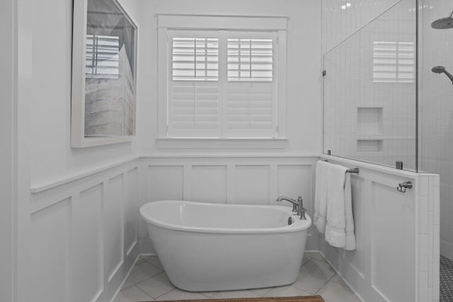 1557 Kepley Dr, Mount Pleasant, SC 29464 - full bath with healthy amount of natural light, a decorative wall, a tile shower, a freestanding tub, and a wainscoted wall