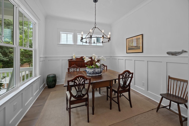 1557 Kepley Dr, Mount Pleasant, SC 29464 - dining area with a decorative wall, dark wood finished floors, a chandelier, ornamental molding, and a wainscoted wall