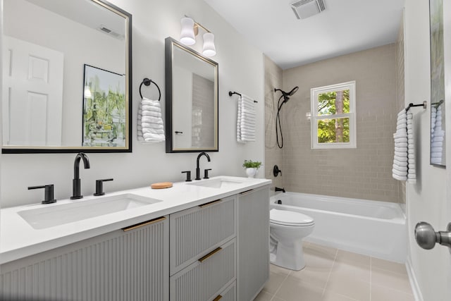 full bath featuring toilet, shower / bath combination, visible vents, and a sink