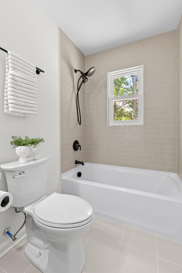 bathroom featuring tile patterned flooring, bathtub / shower combination, and toilet