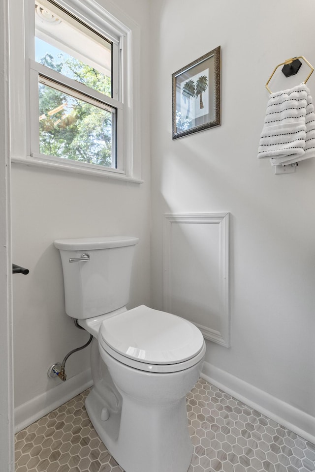 bathroom featuring baseboards and toilet