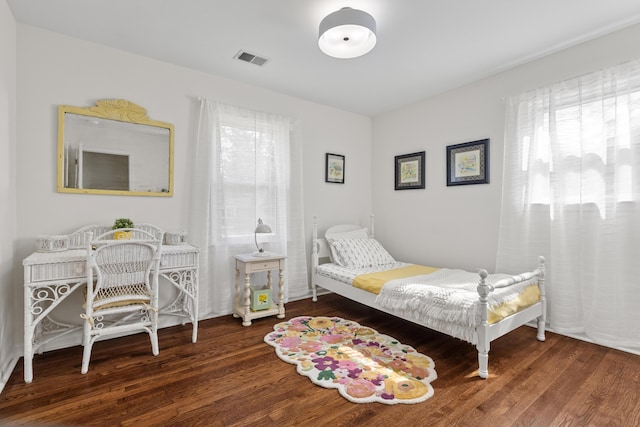 bedroom featuring visible vents and wood finished floors