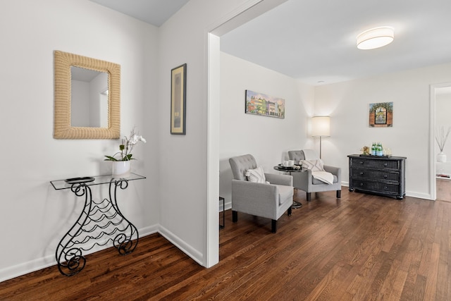 living area featuring baseboards and wood finished floors