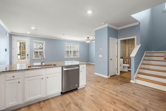 kitchen with dishwasher, sink, ceiling fan, light stone countertops, and white cabinetry