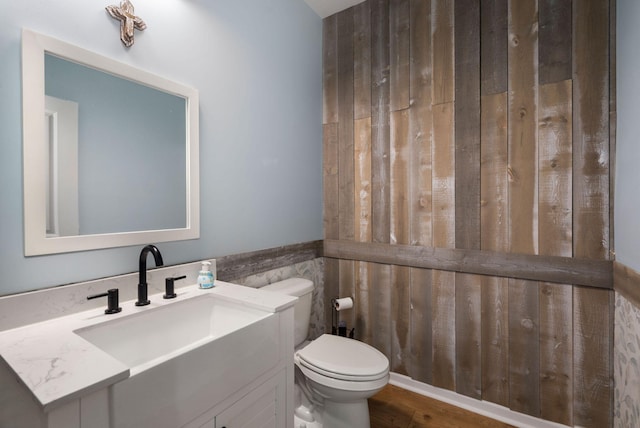 bathroom featuring hardwood / wood-style floors, vanity, and toilet